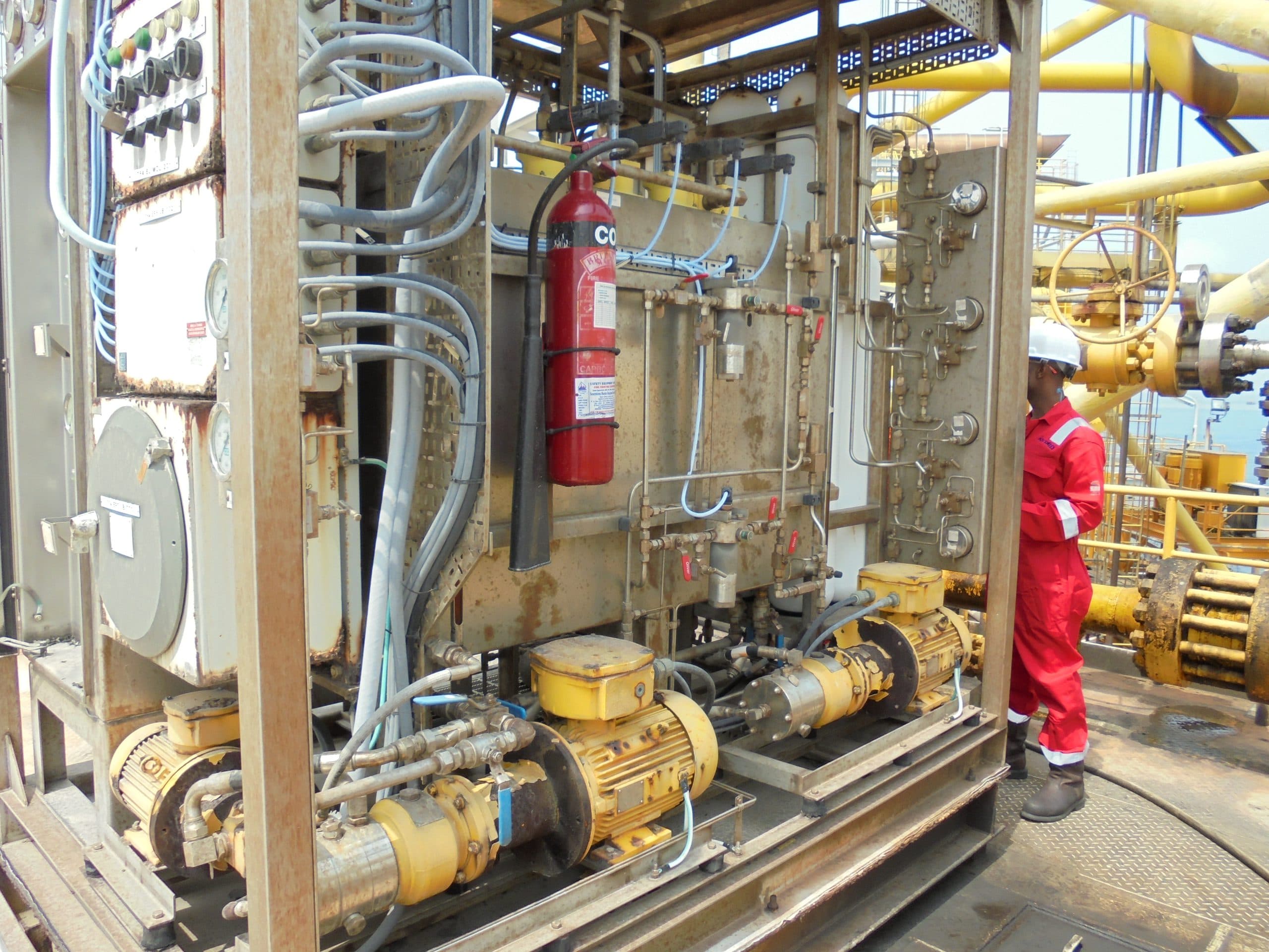 Forza Projects crew at a pump and process skid on a platform